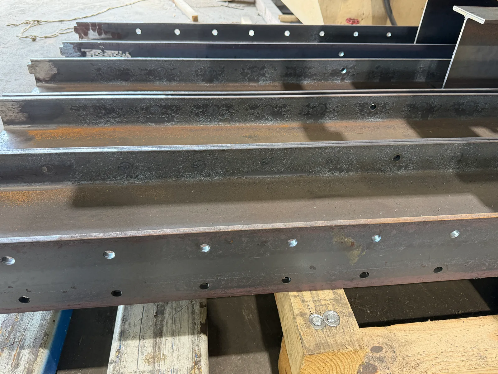 Angle, channel, and I beam with laser cut holes along the length